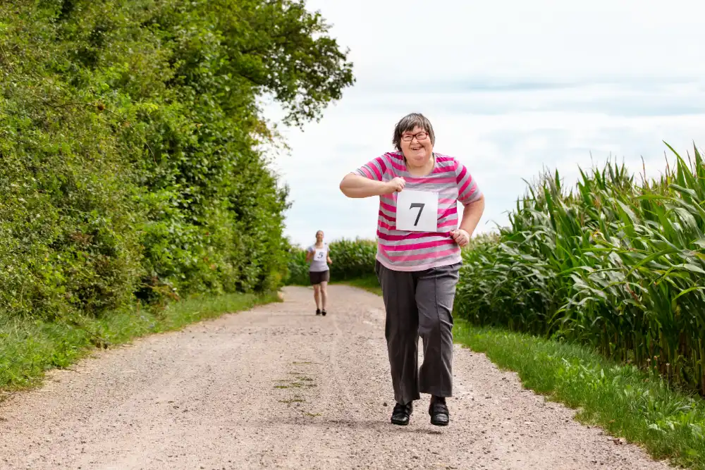 Woman is jogging or running in a fun competition, wearing a number on their top, second woman in the background Woman is jogging or running in a fun competition, wearing a number on their top, second woman in the background