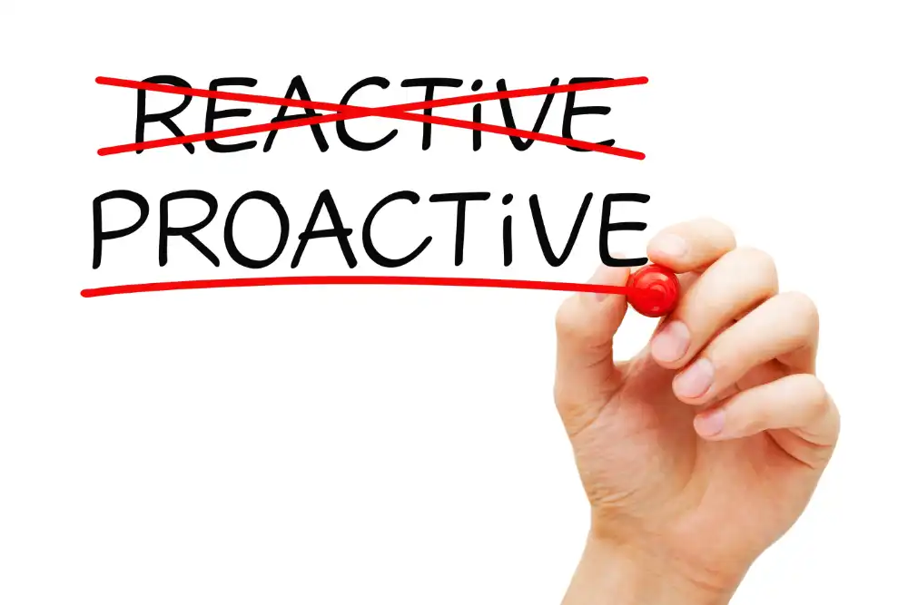 Hand writing Proactive vs Reactive concept about the importance to act in advance to deal with an expected problem, change or difficulty.